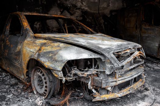 Close up photo of a burned out car in garage after fire for grunge use