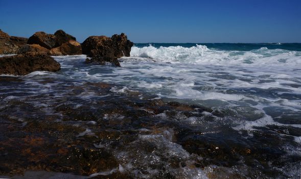 Huge rocks on the coast of the storm sea