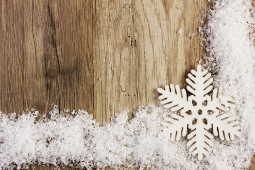 moravian star on snow with wood background