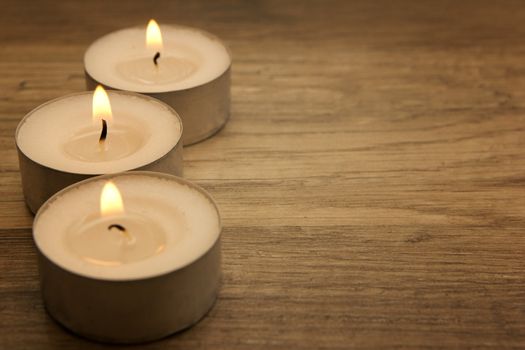 several tealights with wooden background