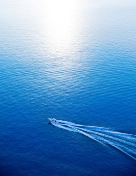 Boat cruising blue Mediterranean sea aerial view in Spain