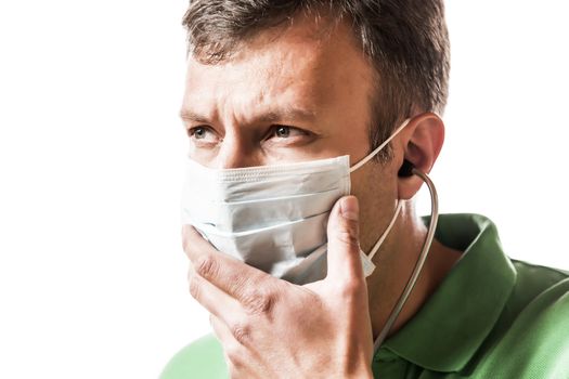 Desperate doctor in green shirt with surgical mask