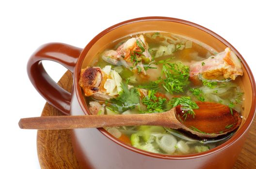 Vegetable Soup with Cabbage, Leek, Carrot, Garlic Greens and Smoked Pork Ribs in Brown Bowl with Wooden Spoon isolated on white background