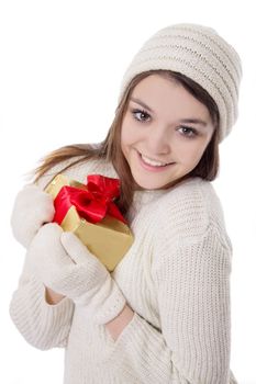 Cute teenage girl in knitted mitten and hat with gift isolated over white
