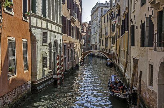 View of a canal, gondolas, and typical buildings in Venice, Italy.