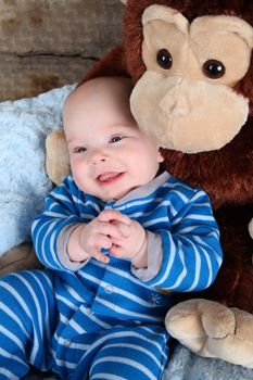 Cute baby boy sitting with his bears