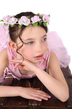 Brunette ballet girl against a white background wearing pink