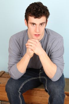 Attractive brunette male model in casual grey shirt