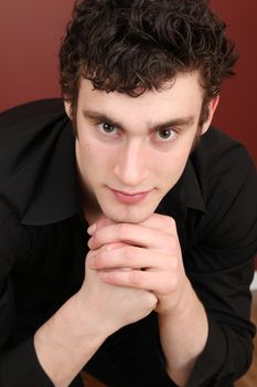 Attractive brunette male model against dark red background