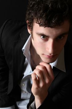 Attractive brunette male model in black dress shirt