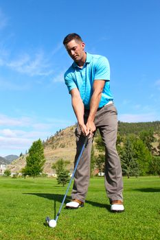 Young golfer hitting a shot with an iron
