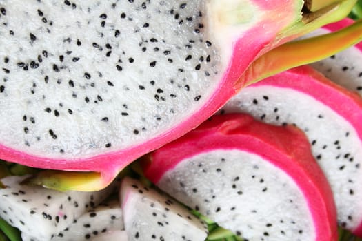 Pink pitahaya dragon fruit background sliced in pieces
