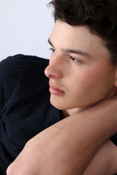 Attractive brunette male model on grey background wearing black