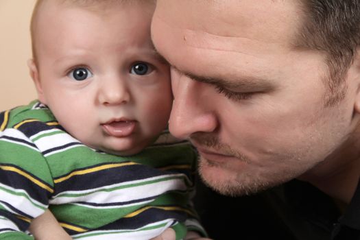 Father and young baby with faces close together