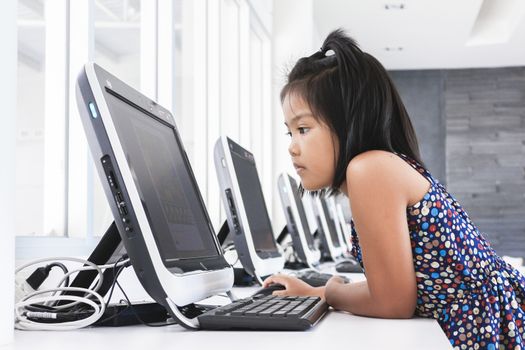 Asian children to playing with computer