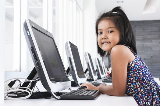 Asian children to playing with computer