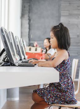 Asian children to playing with computer