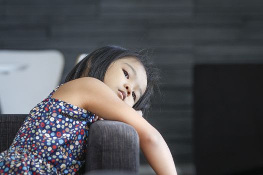 Relaxing time of asian children on sofa