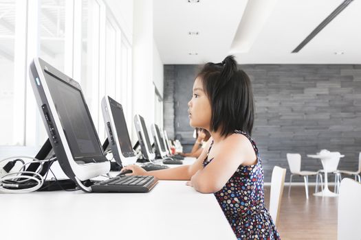 Asian children to playing with computer