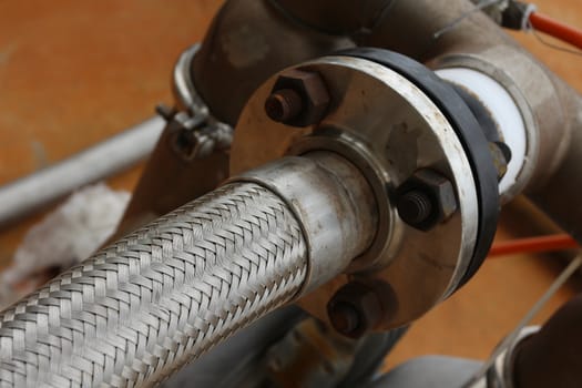 Close-up of Flexible hose with steel pipe line