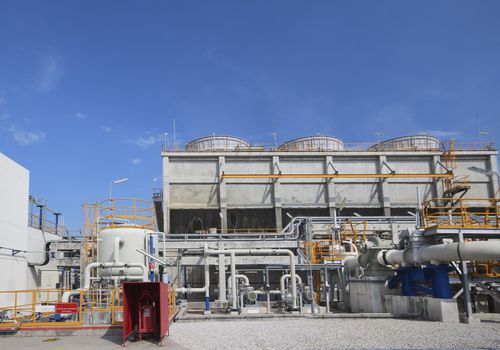 Cooling tower in industrial plant with blue sky