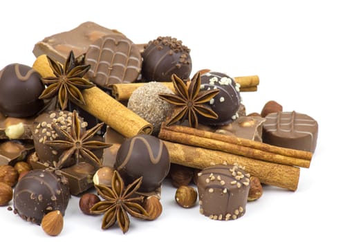 chocolate, spices and nuts on white background