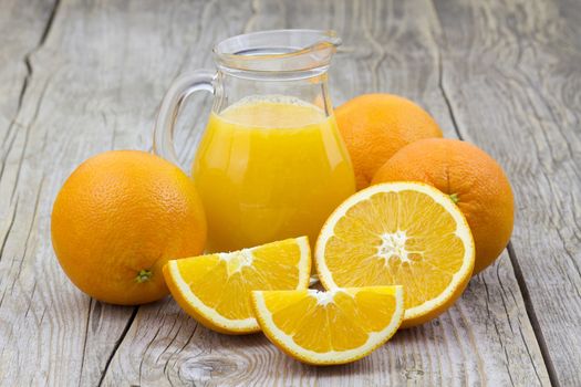 orange juice and fresh fruits on wooden background