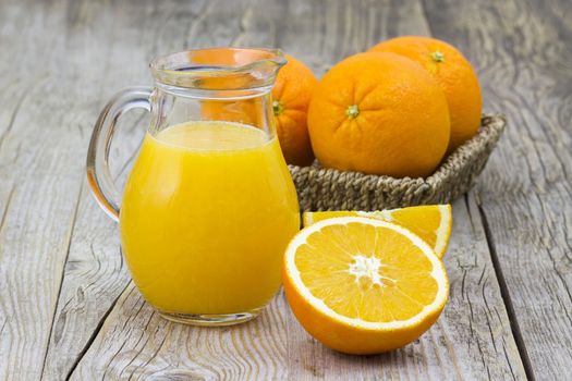 orange juice and fresh fruits on wooden background
