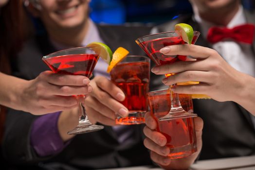 close-up of hands with glasses, a toast, party with friends