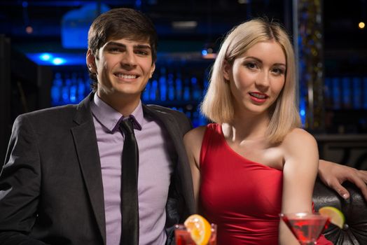 Young couple talking in a nightclub, have fun