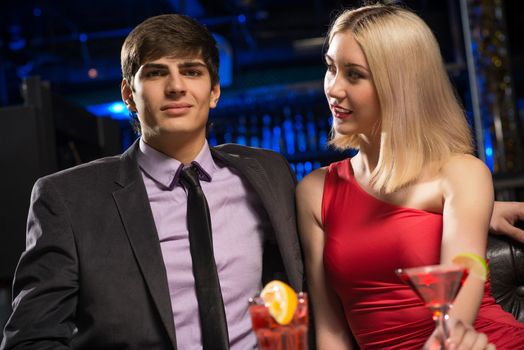 Young couple talking in a nightclub, have fun