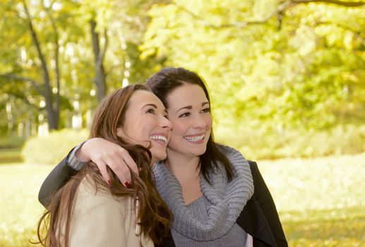 laughing girlfriends in autumn park