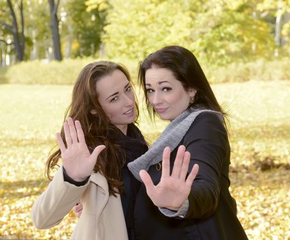 two angry women showing stop
