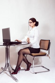portrait of young businesswoman at desk with computer