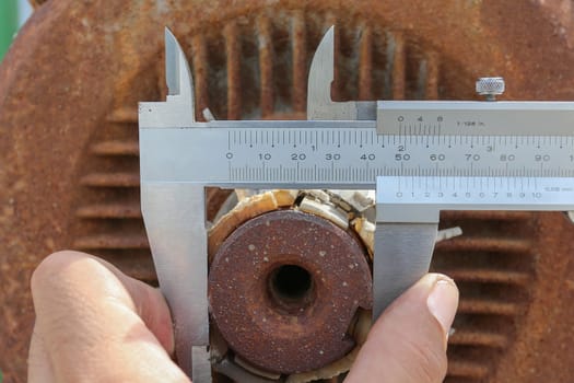 A man use vernier caliper to check diameter of Engine 