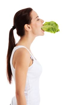 Beautiful woman with leaf of lettuce in mouth. Isolated on white.