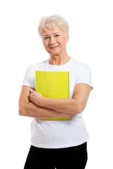 An old woman holding a workbook. isolated on white.