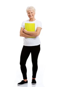 An old woman holding a workbook. isolated on white.