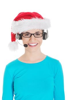 Young casual woman in santa hat and,microphone and headphones. Isolated on white.