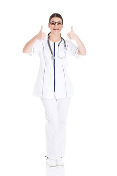 Young beautiful doctor, nurse with stethoscope showing ok. Isolated on white.