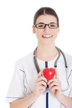 Beautiful young female doctor holding a heart. Isolated on white.