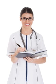 Young female doctor wirting in a book. Isolated on white.