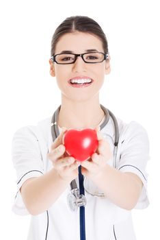 Beautiful young female doctor holding a heart. Isolated on white.