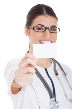 Young female doctor holding business card. Isolated on white.