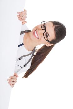 Young female doctor holding copy space. Isolated on white.