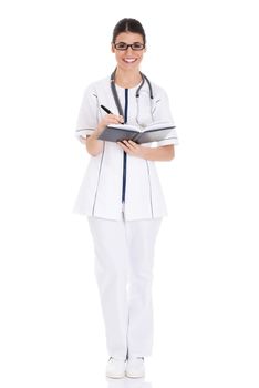 Young female doctor wirting in a book. Isolated on white.