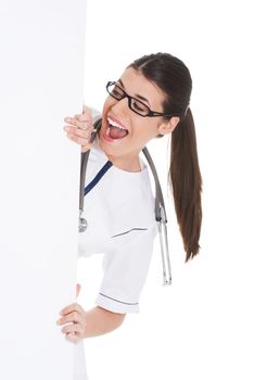 Young female doctor holding copy space. Isolated on white.