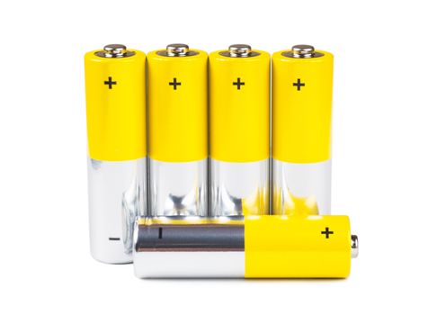 A row of yellow batteries isolated over white background