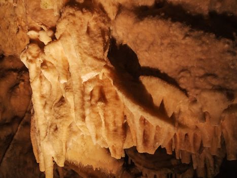 A yellow orange stalagmite in the cave