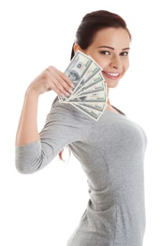 Beatiful casual woman holding money. Isolated on white.